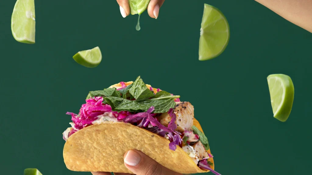Fresh taco with chicken, vibrant veggies, and lime juice