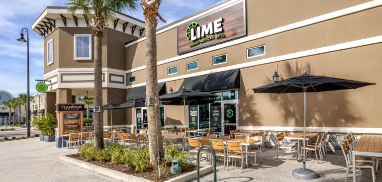 Lime Fresh Mexican food franchise exterior featuring patio seating with umbrellas
